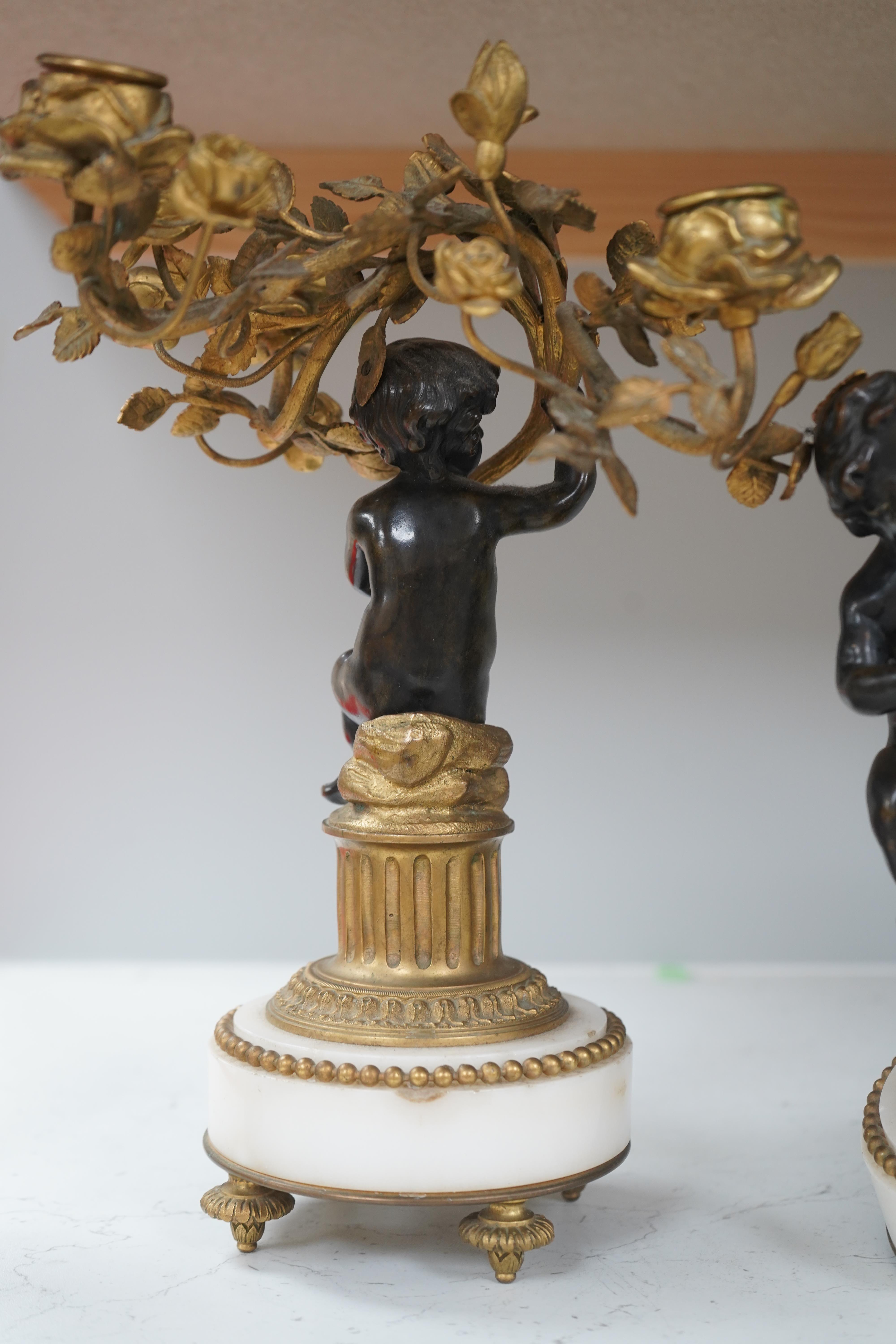 A pair of Louis XVI style bronze, ormolu and white marble figural candelabra, late 19th century, 28cm. Condition - as photographed